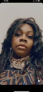 Shemeka Campbell in a casual beaded necklace and patterned top